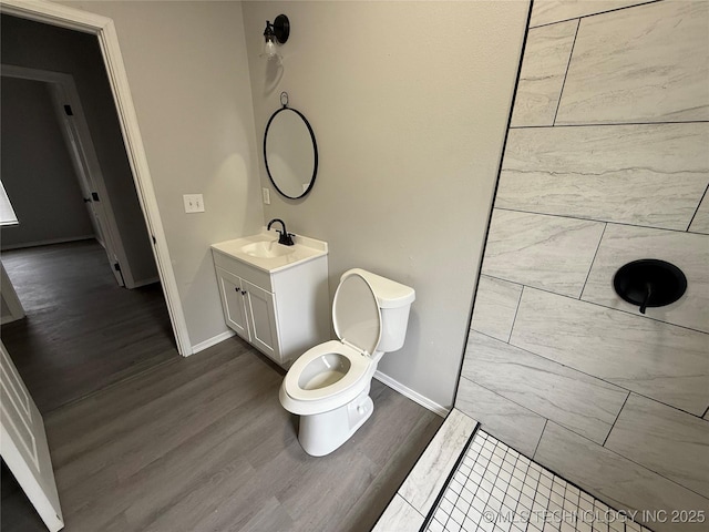 bathroom featuring toilet, vanity, and hardwood / wood-style flooring