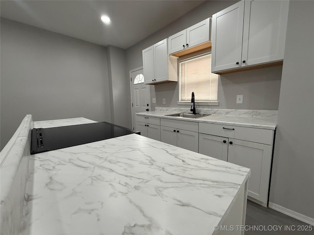 kitchen featuring sink and white cabinetry