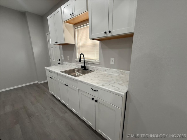 kitchen featuring sink, white cabinetry, and dark hardwood / wood-style flooring