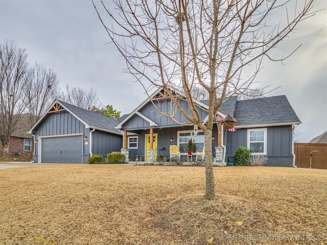 craftsman inspired home with a front lawn, a porch, and a garage