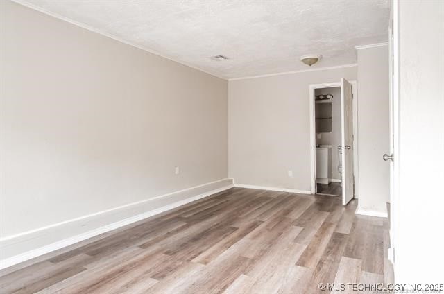 unfurnished room with a textured ceiling and hardwood / wood-style flooring