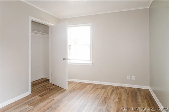 unfurnished bedroom featuring a closet and light wood-type flooring