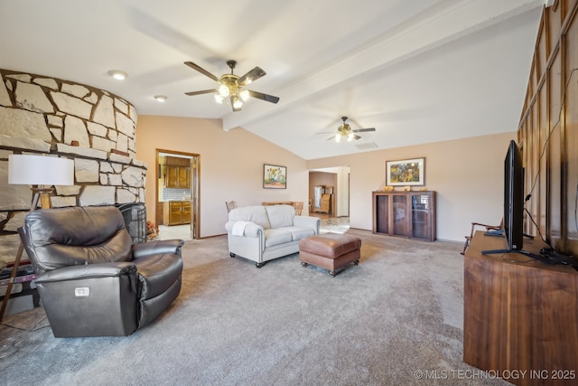 living room featuring a stone fireplace, carpet flooring, vaulted ceiling with beams, and ceiling fan