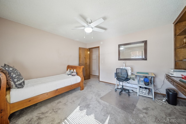 carpeted bedroom with ceiling fan and a textured ceiling