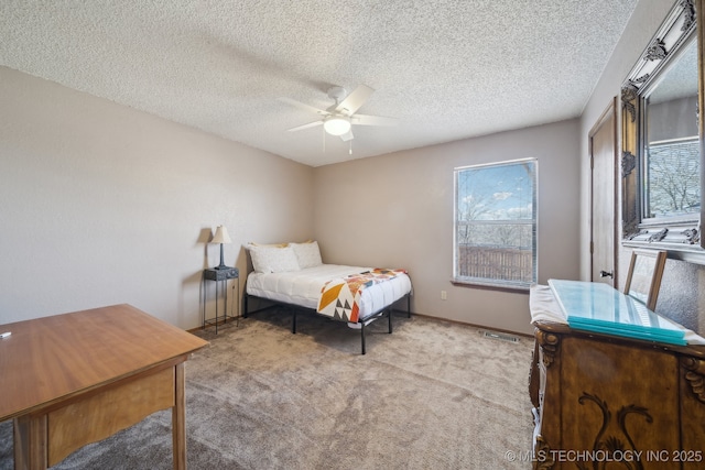 bedroom with light colored carpet, a textured ceiling, and ceiling fan