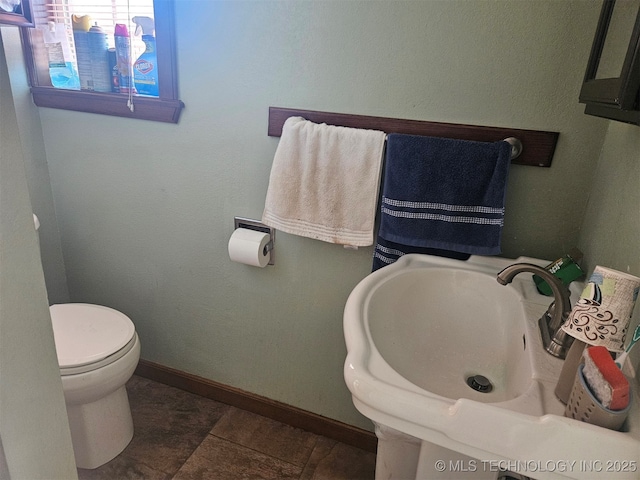 bathroom featuring tile patterned flooring, sink, and toilet