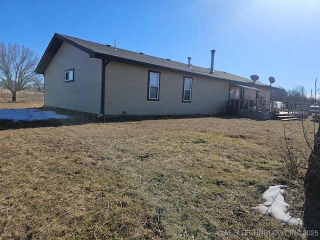 back of house featuring a yard and a deck