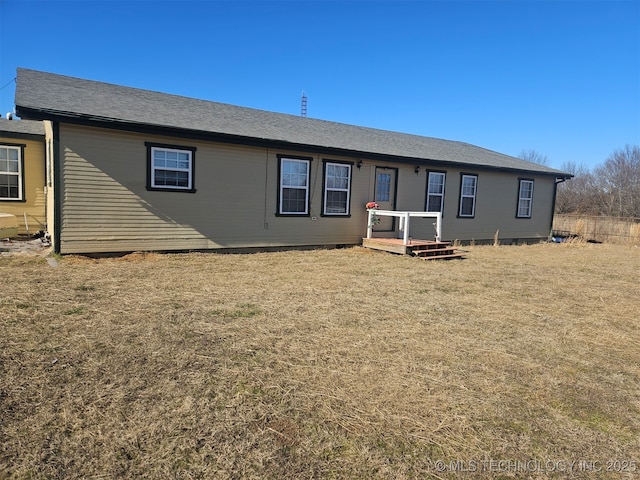 rear view of property with a lawn