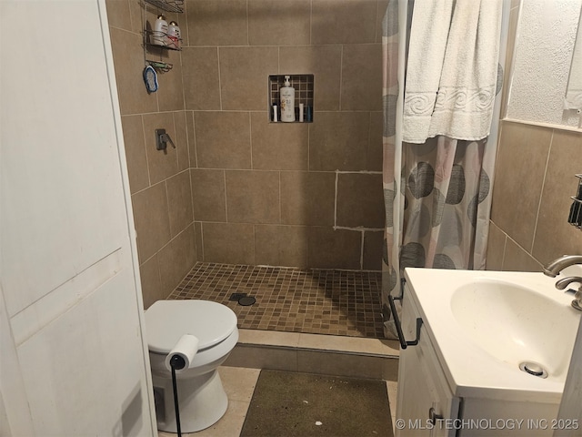 bathroom featuring tile patterned flooring, toilet, vanity, and a shower with shower curtain