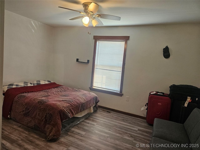 bedroom with hardwood / wood-style flooring and ceiling fan