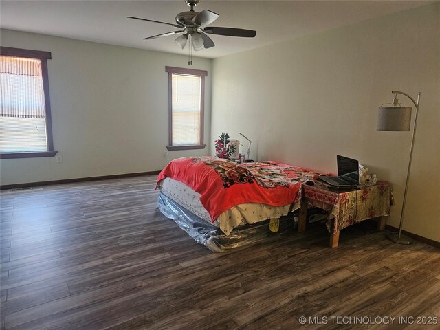 bedroom with dark wood-type flooring and ceiling fan