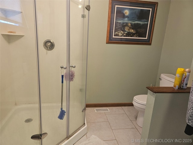 bathroom with walk in shower, toilet, and tile patterned flooring