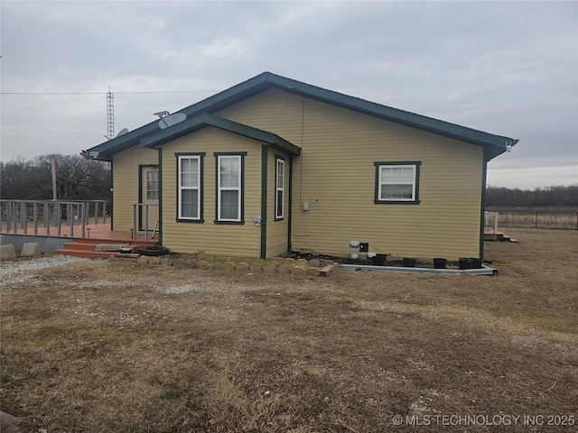 view of home's exterior featuring a lawn and a deck