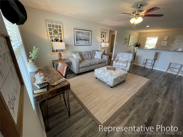 living room with ceiling fan and dark hardwood / wood-style floors