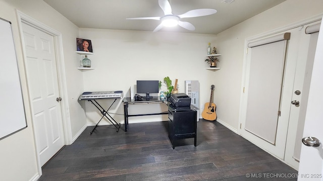 home office with ceiling fan and dark hardwood / wood-style flooring