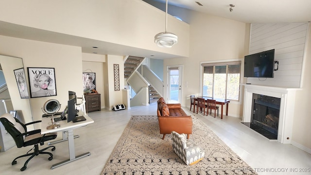 interior space with high vaulted ceiling and a large fireplace