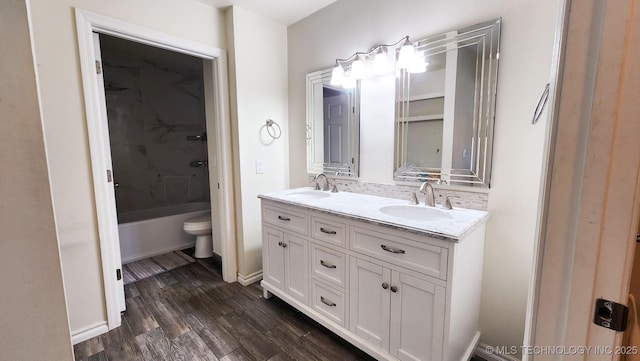 bathroom featuring hardwood / wood-style flooring, toilet, and vanity