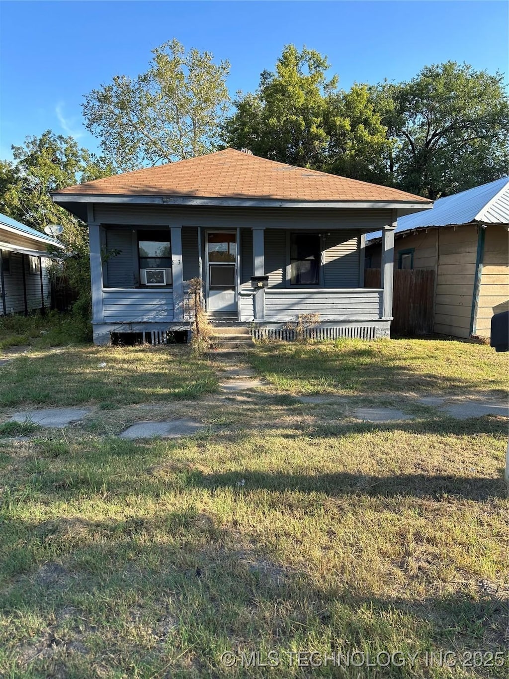 view of front of home featuring a front yard and a porch