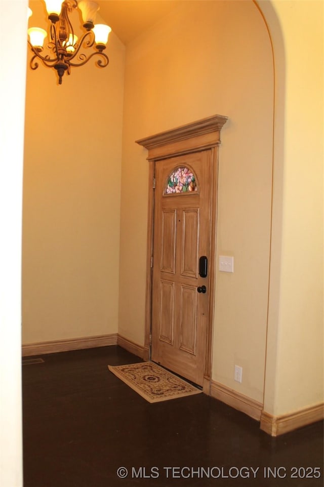 foyer entrance with a chandelier