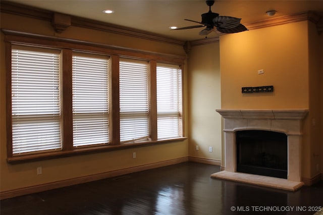 unfurnished living room with ceiling fan, dark hardwood / wood-style flooring, and ornamental molding