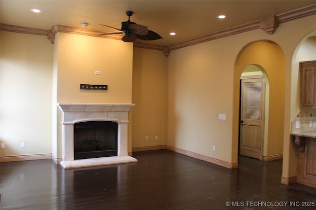 unfurnished living room featuring ceiling fan, crown molding, and dark hardwood / wood-style floors