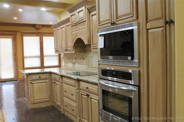 kitchen with backsplash, light stone countertops, light brown cabinets, and stainless steel appliances