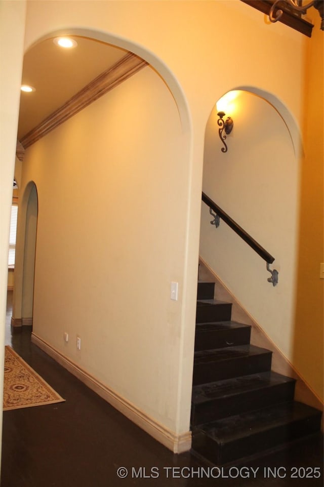 stairway featuring ornamental molding