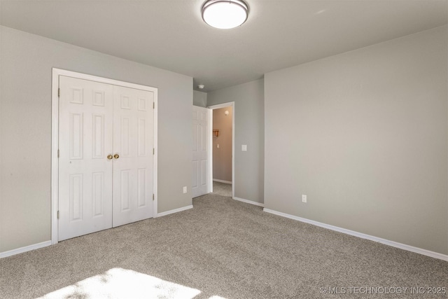 unfurnished bedroom featuring carpet and a closet