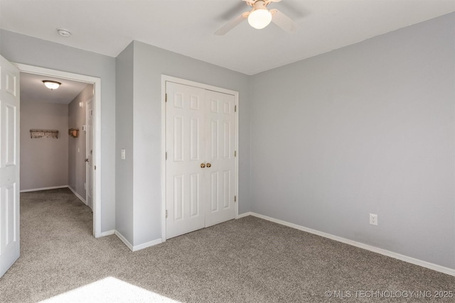 unfurnished bedroom featuring ceiling fan, a closet, and light carpet