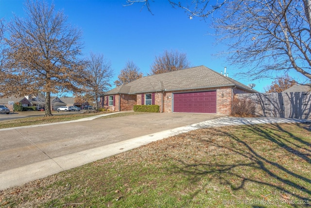 single story home with a front yard and a garage