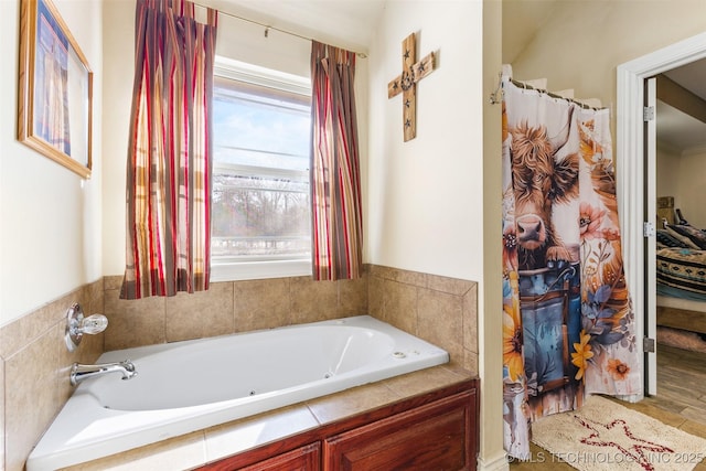 bathroom with a relaxing tiled tub