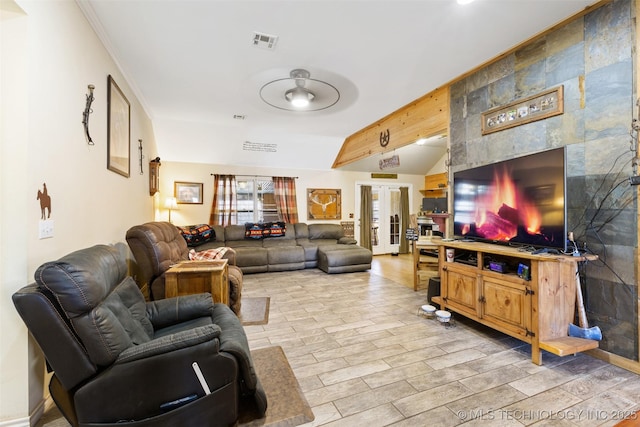 living room featuring beam ceiling and french doors