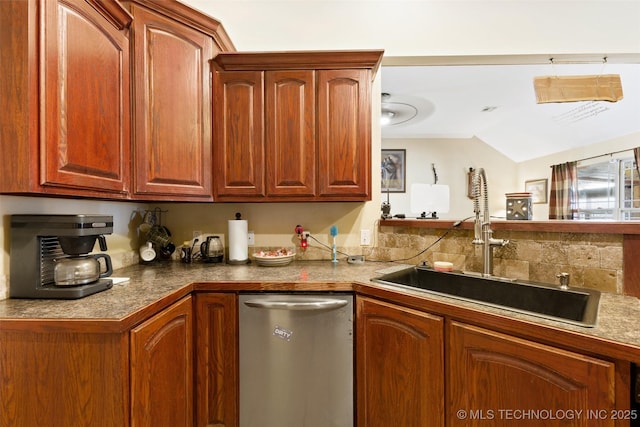 kitchen featuring lofted ceiling, stainless steel dishwasher, and sink