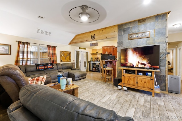 living room featuring ceiling fan and lofted ceiling with beams