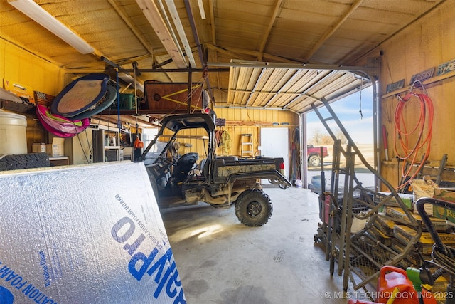 garage featuring wood walls