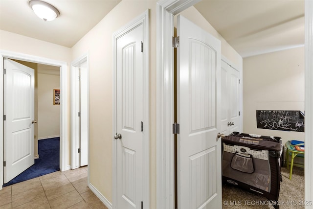 corridor featuring light tile patterned floors