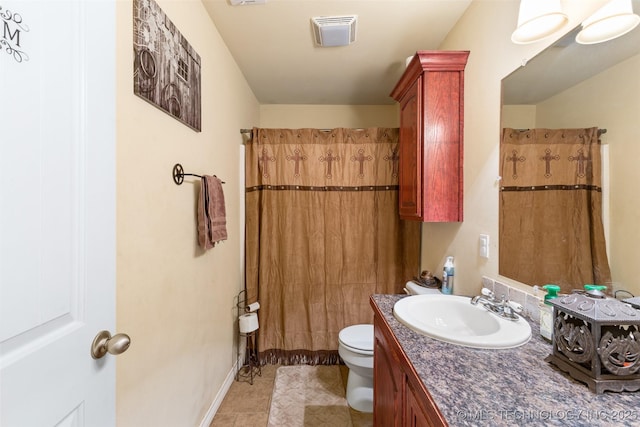 bathroom featuring toilet, vanity, walk in shower, and tile patterned flooring