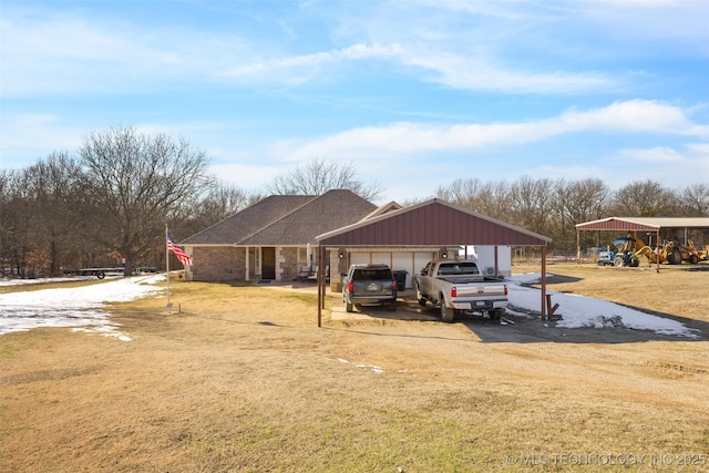 exterior space with a garage, a carport, and a yard