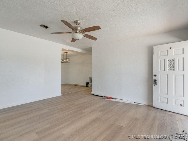 unfurnished room featuring ceiling fan, a textured ceiling, and light wood-type flooring