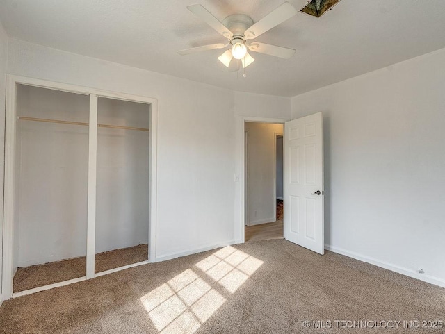 unfurnished bedroom with carpet, ceiling fan, and a closet