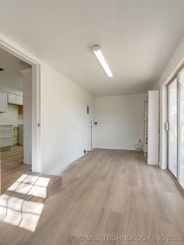 spare room with light wood-type flooring