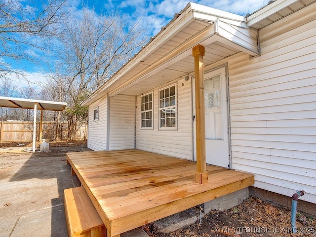 view of exterior entry featuring a wooden deck