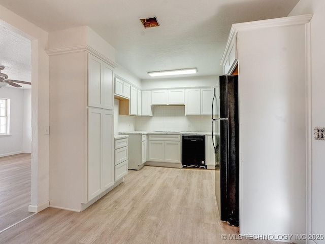 kitchen with light hardwood / wood-style flooring, ceiling fan, tasteful backsplash, black appliances, and white cabinets