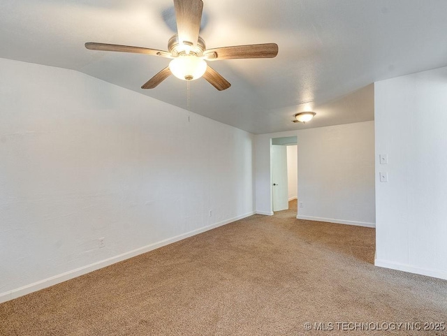 carpeted spare room with ceiling fan