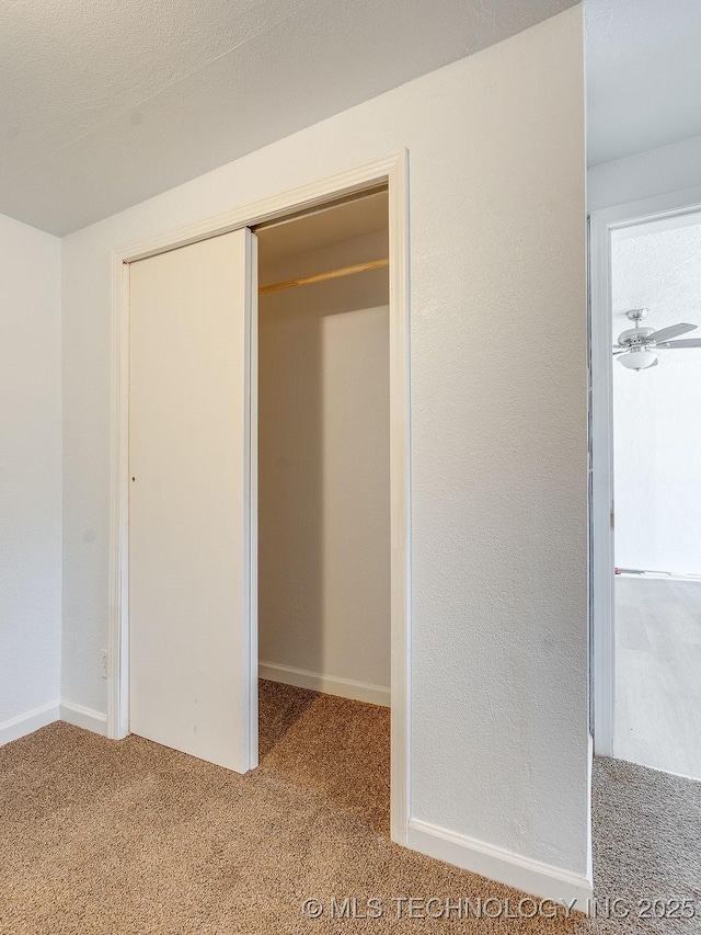 unfurnished bedroom with carpet flooring and a closet