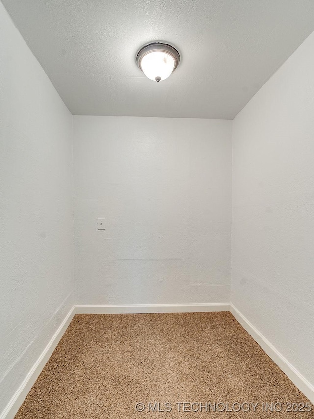 carpeted spare room featuring a textured ceiling