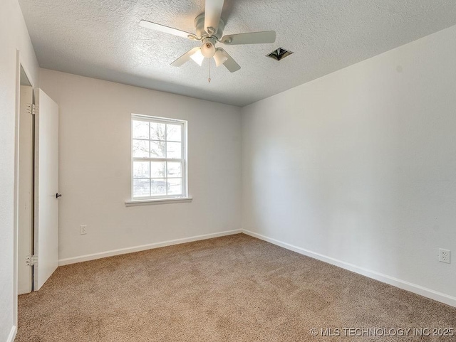 unfurnished room featuring ceiling fan, carpet floors, and a textured ceiling