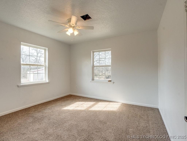 spare room with a textured ceiling, ceiling fan, and carpet flooring