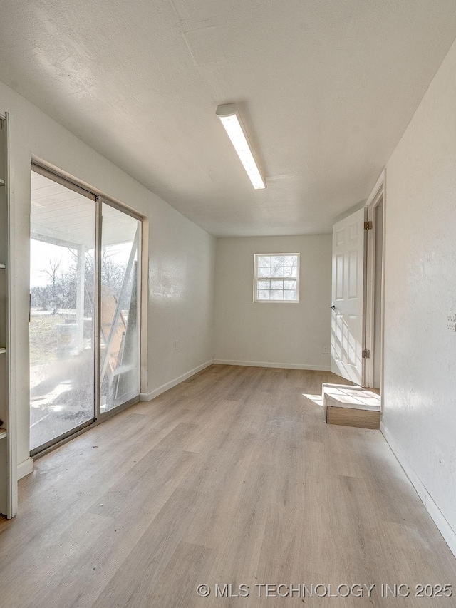 unfurnished room with light hardwood / wood-style flooring