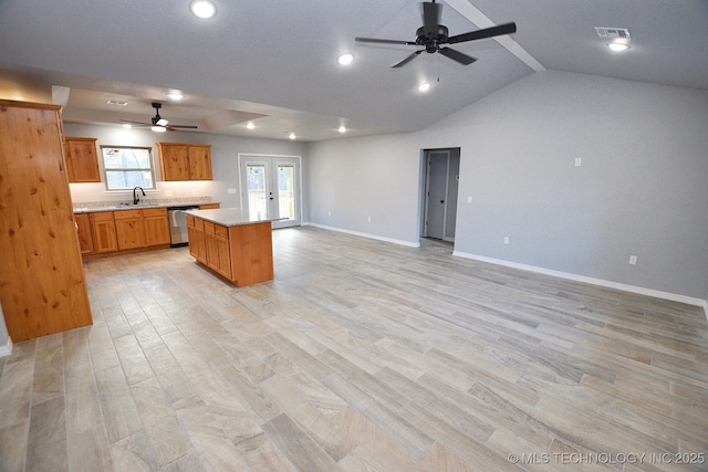 kitchen with dishwasher, a kitchen island, sink, light hardwood / wood-style flooring, and french doors